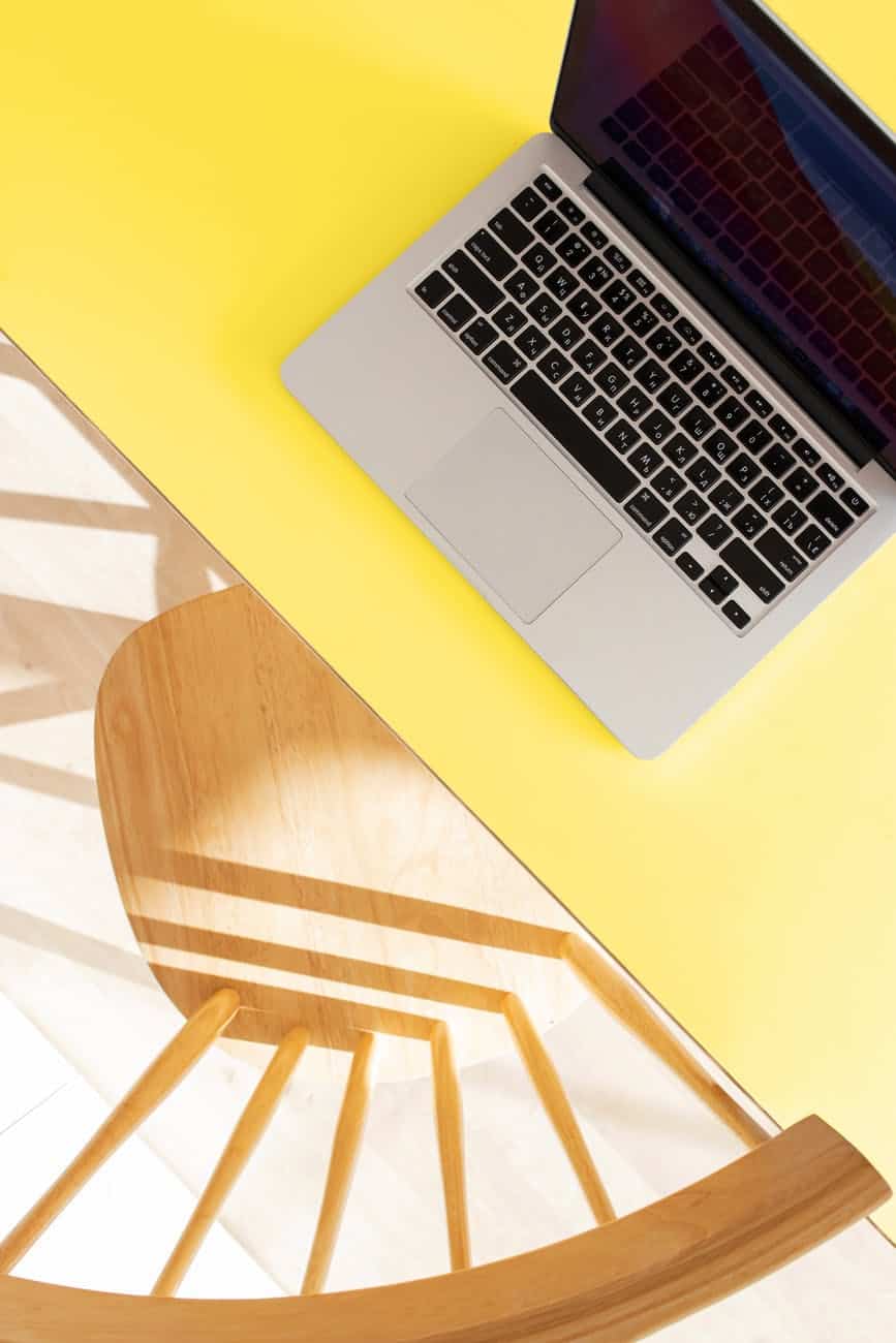 macbook pro on yellow table